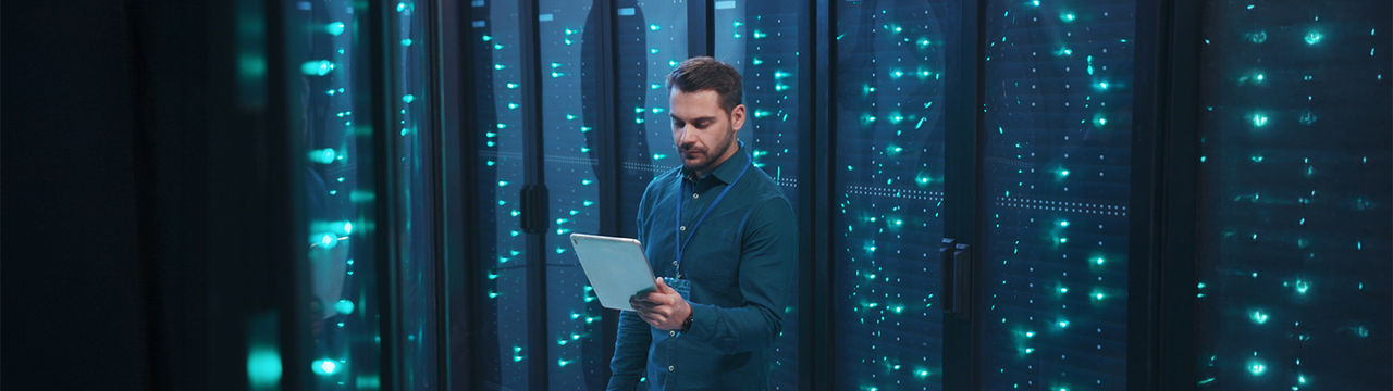 Engineer in data center with servers.