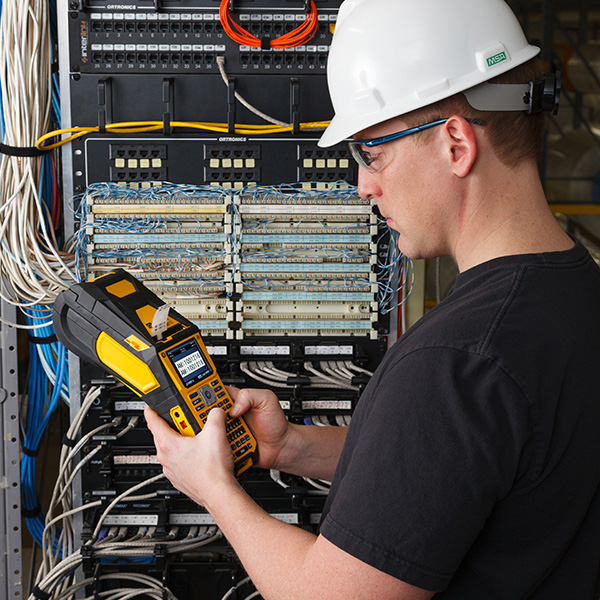 Man using Brady label printer in data center