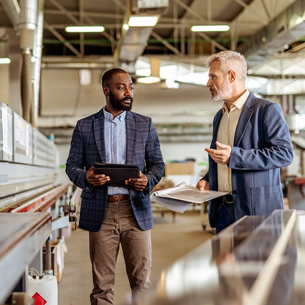 Managers walk manufacturing facility
