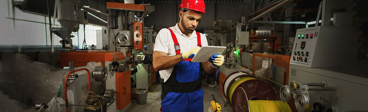 Man using tablet in cable supply factory