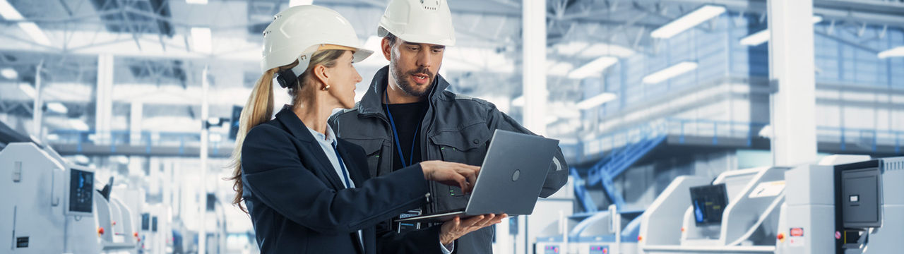 Engineers with laptop in modern facility
