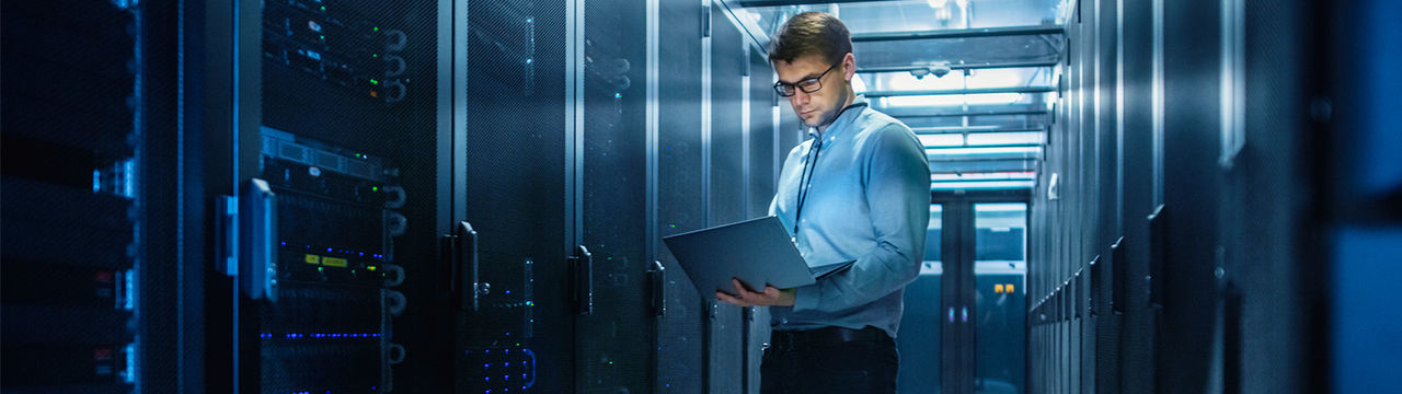 Man with laptop in data center