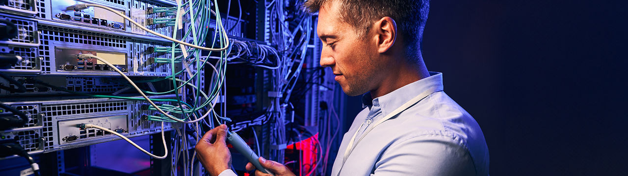 Data center employee checking cabling infrastructure