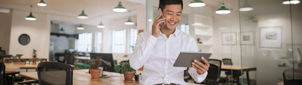 Office employee using wireless technology in a hyperconnected building.