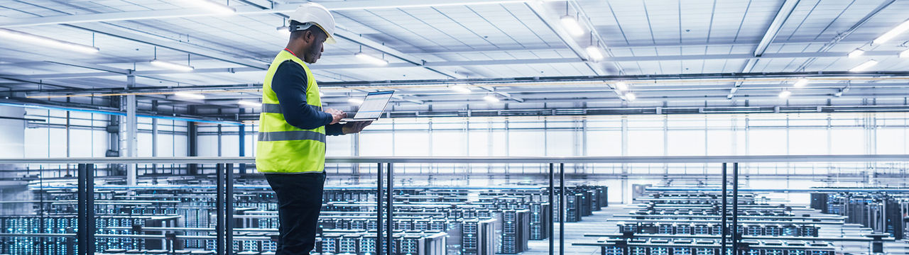 Man with hardhat in large data center