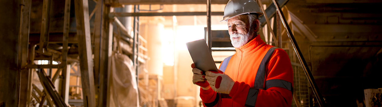 Miner using tablet in underground facility