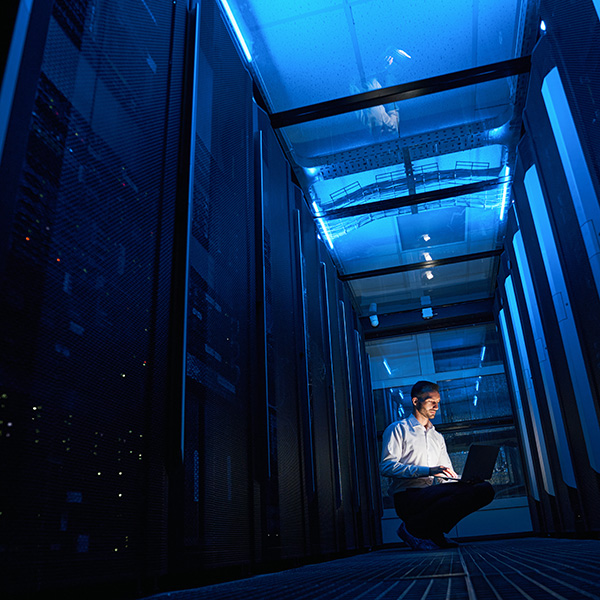 Data center engineer monitoring servers.