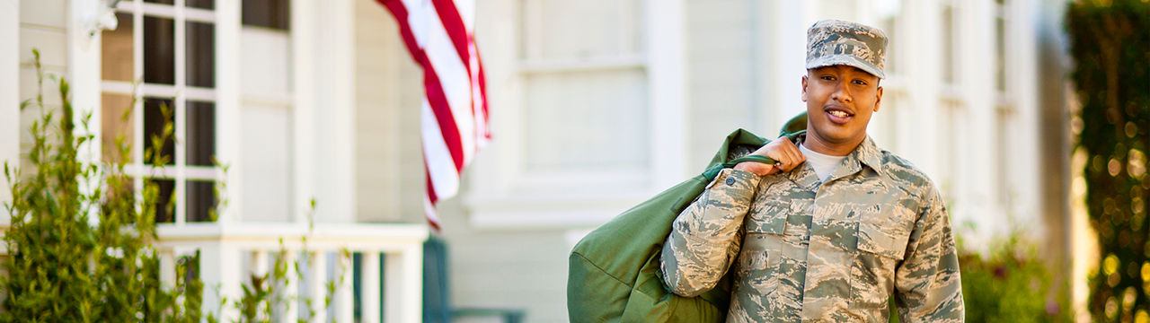 Soldier outside his home