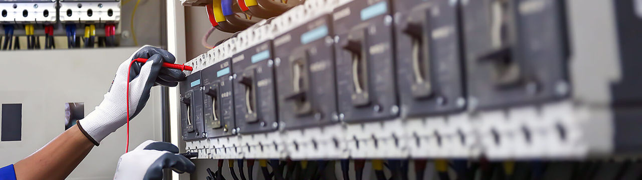 Electrician hand checking electric current voltage