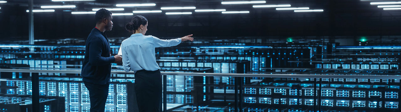 Engineers overlooking large data center