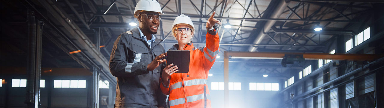 Industrial workers with safety gear in warehouse