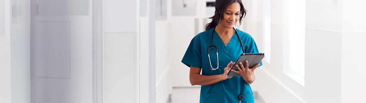 Doctor using tablet in hospital hallway