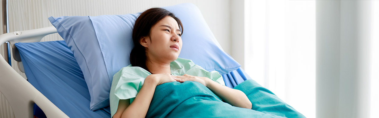 Distressed patient in hospital medical facility bed.