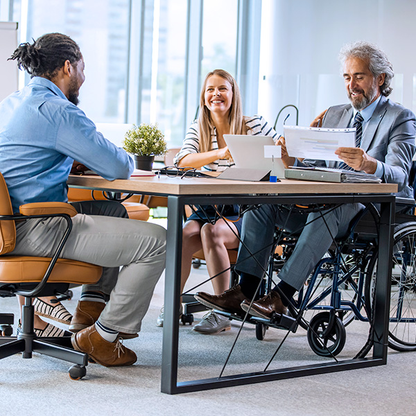 Disabled business executive in wheelchair at meeting