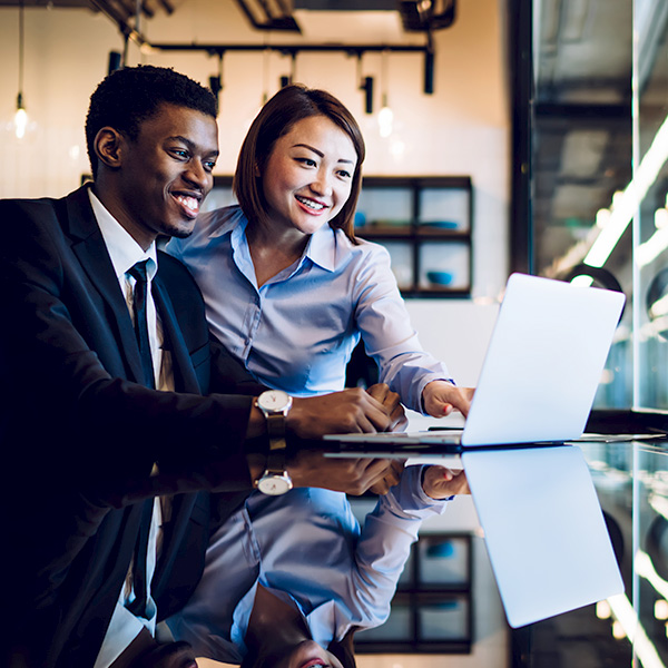 Diverse coworkers looking at laptop