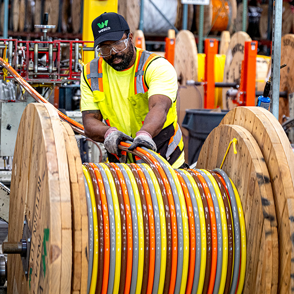 Wesco worker spooling cable on Insta Reel