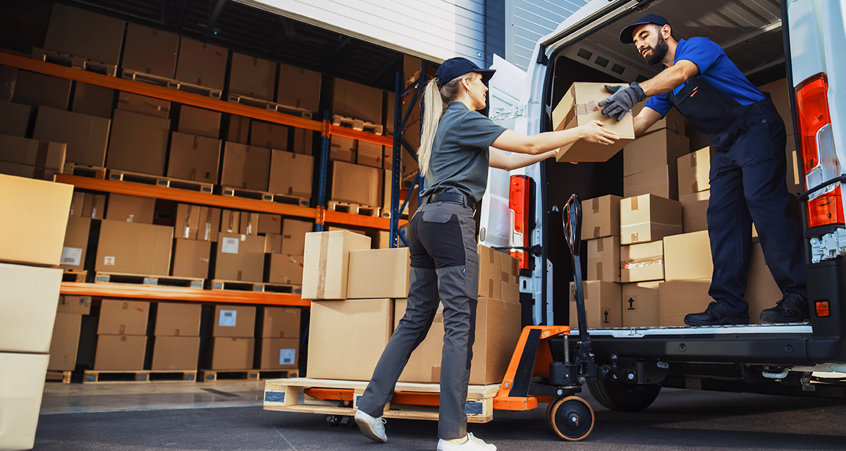 Workers loading boxes in van