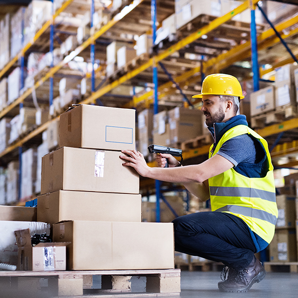 Warehouse worker scanning boxes.