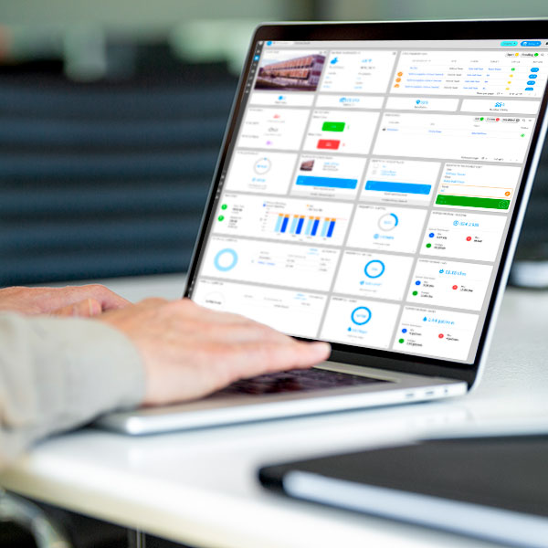 Facility manager using platform software on laptop.