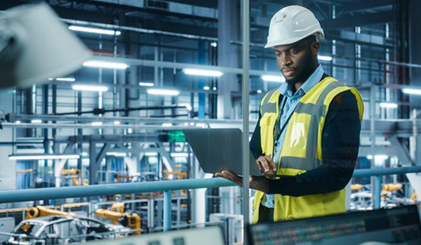 Man in automation factory office working on a laptop