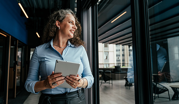 Professional woman using wi-fi device in modern office.