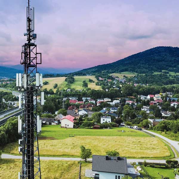 Telecommunications tower and town landscape in mountains