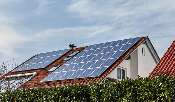 House with solar panels on rooftop.